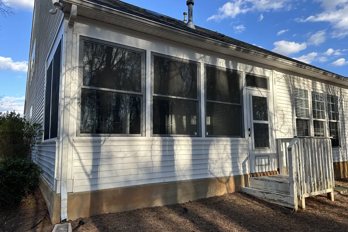 Existing deck structure before 3-season vinyl enclosure installation in Elrose Charlotte