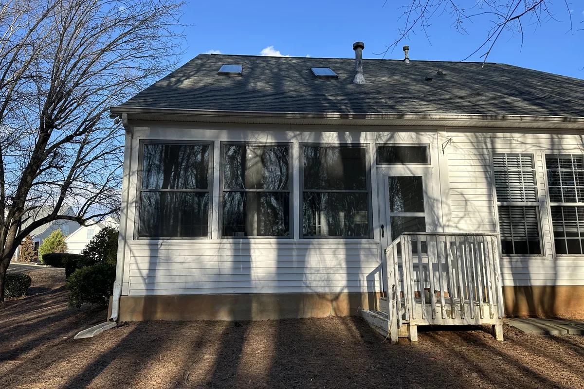 Completed 3-season porch enclosure exterior view in Elrose, Charlotte NC with vinyl film deck