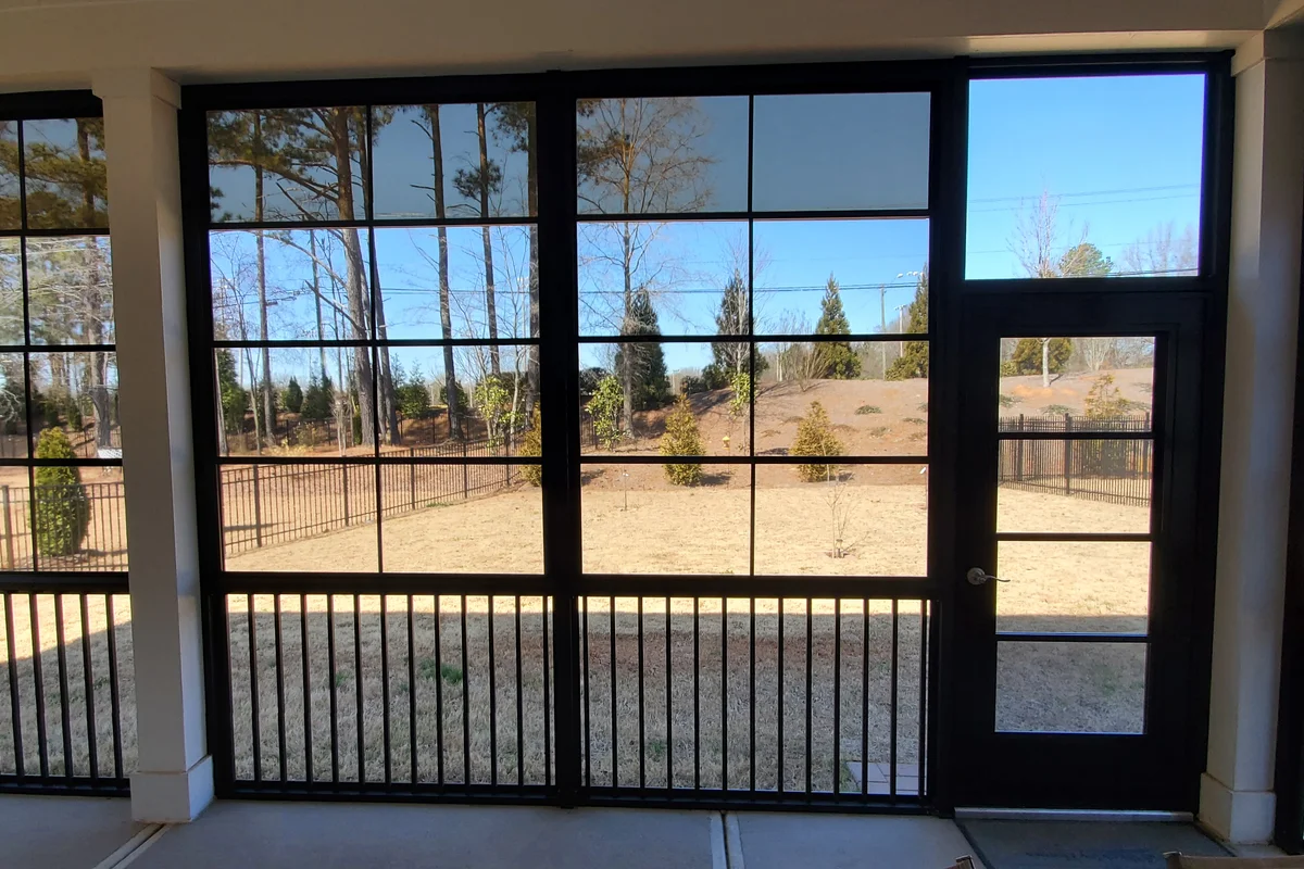 Finished 3-season sunroom with vinyl film enclosure at Livery Stable Matthews NC