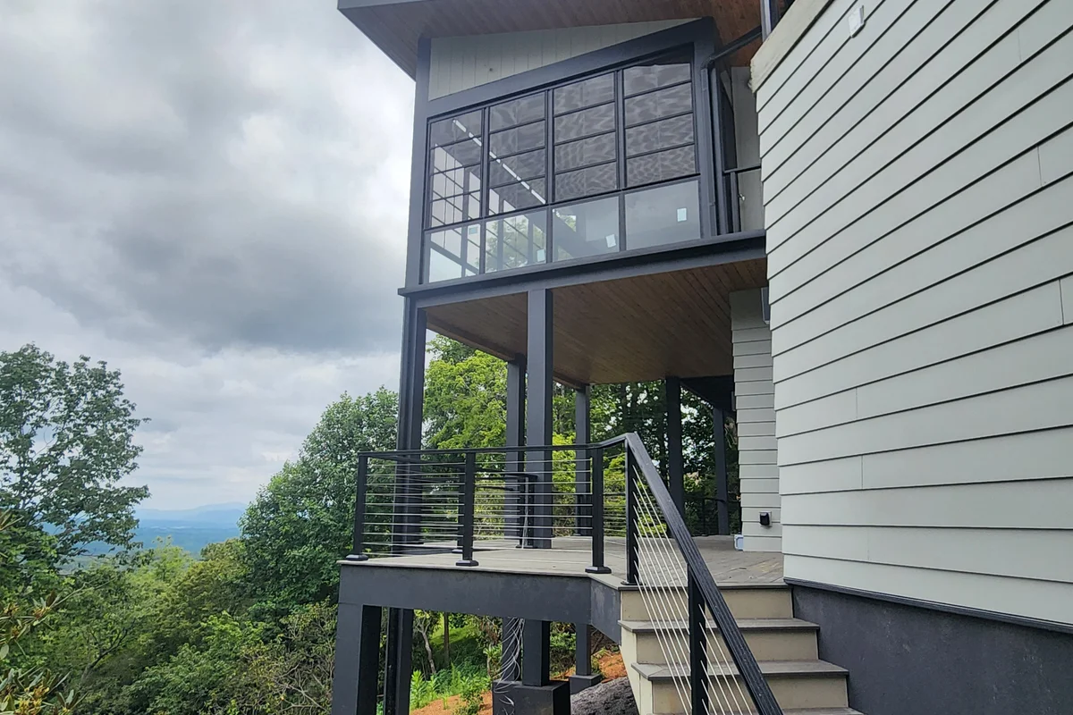 Completed 3-season vinyl film porch enclosure exterior in Mills River Horse Shoe NC