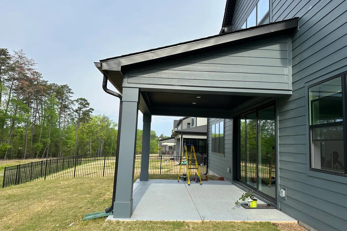 Existing porch structure before vinyl film enclosure installation in Tega Cay
